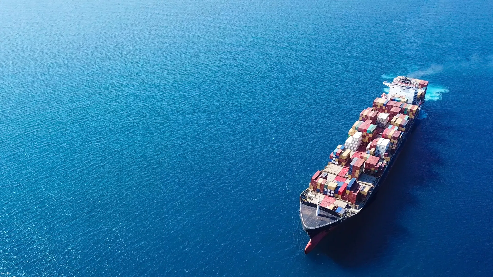 Large cargo vessel at sea in atmospheric conditions